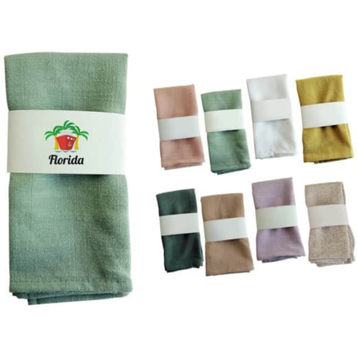 A green linen cotton tea towel with matching pastel-coloured folded towels, featuring a logo.