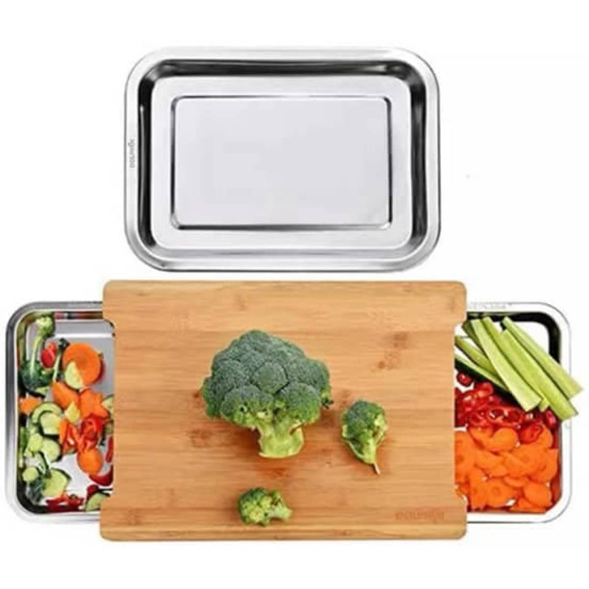 A bamboo chopping board with two stainless steel trays, featuring chopped vegetables and a whole broccoli.