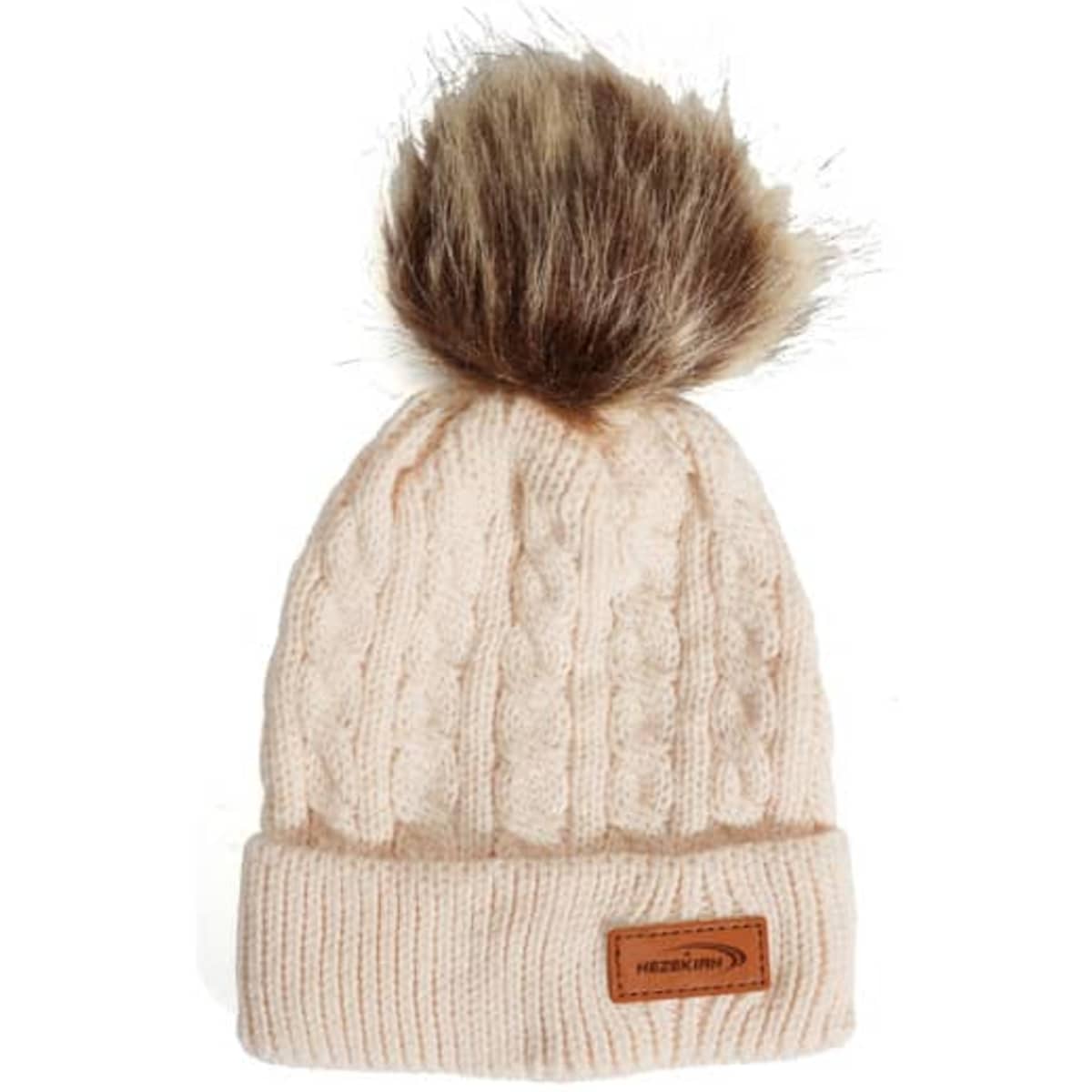 A cream beanie with a knitted pattern and a plush fox fur pom pom on top, featuring a small logo tag.