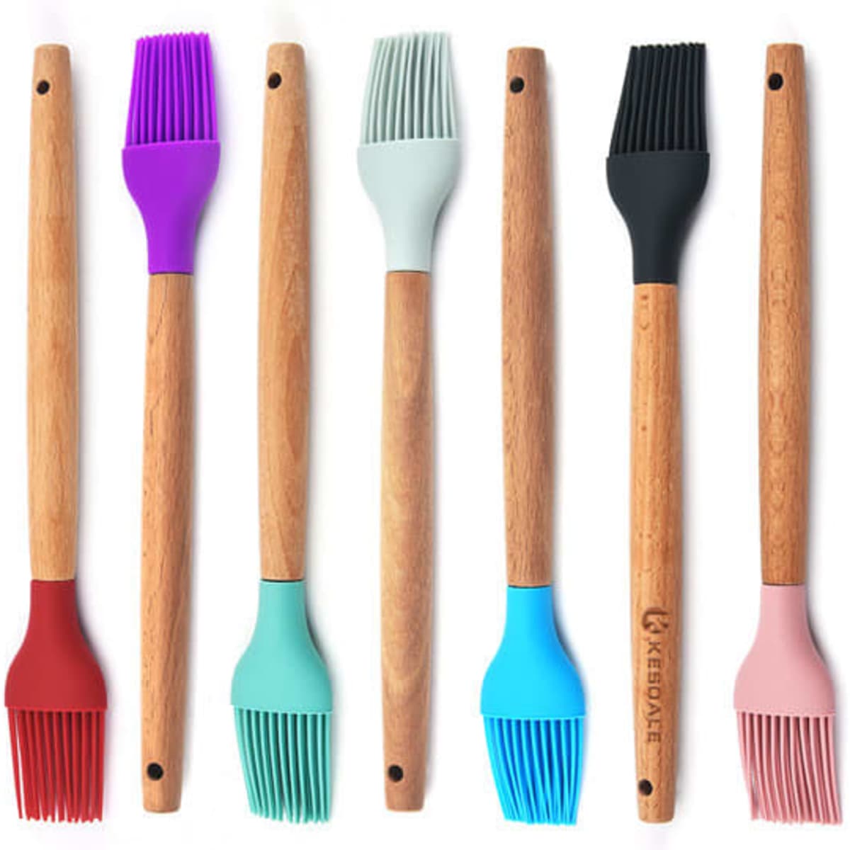 A set of silicone basting brushes in various colours, featuring wooden handles and a brand logo on one brush.