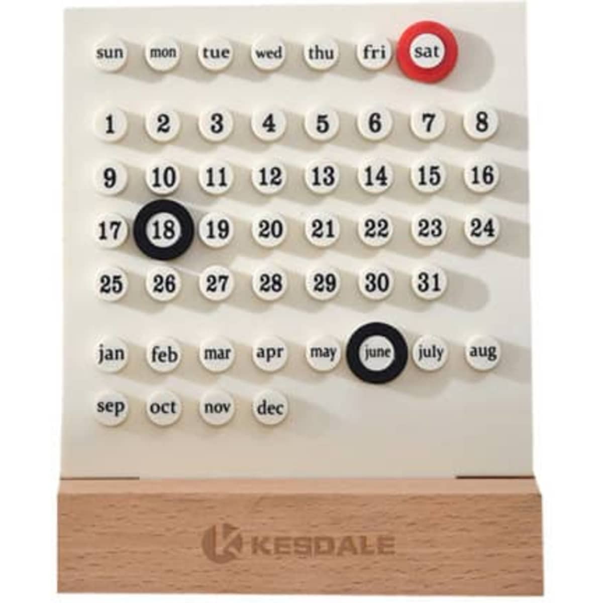 A perpetual calendar with white circular date tiles, black and red markers, and a wooden base. It features a logo.