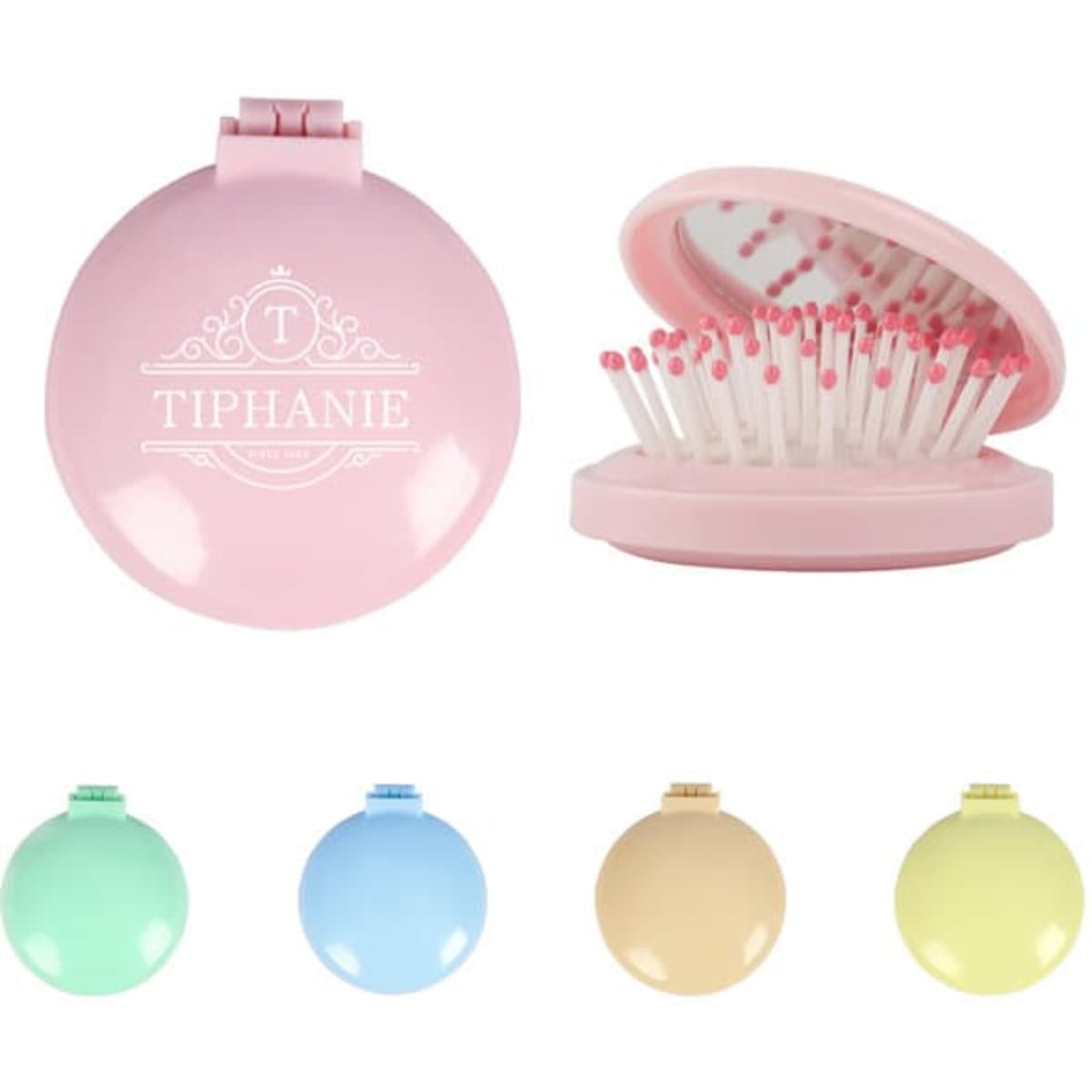 A pink plastic folding massage comb with a mirror, featuring a branded logo, alongside other coloured options.