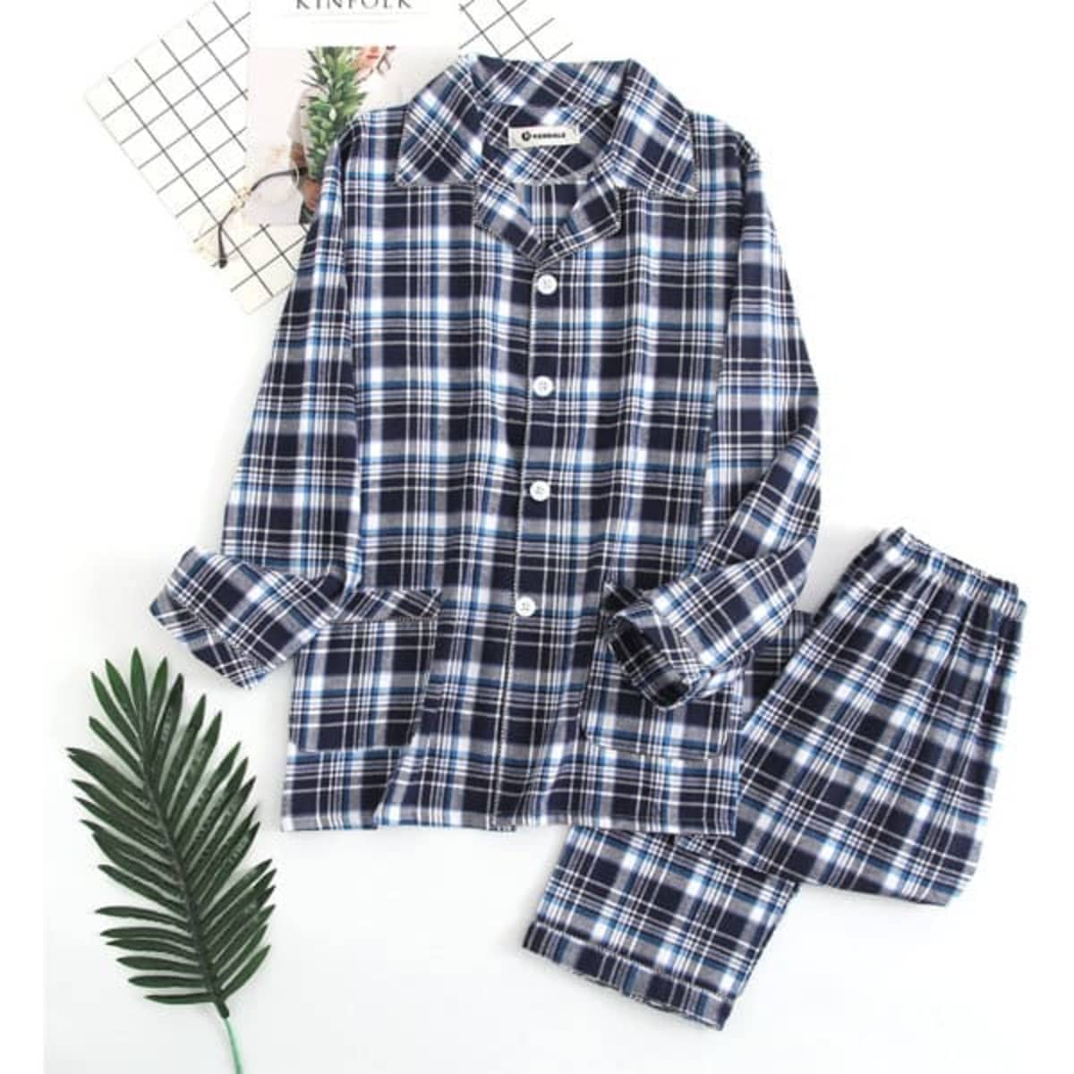 A navy and white checked flannel pajama set for men, featuring a button-up top and elastic waist pants.