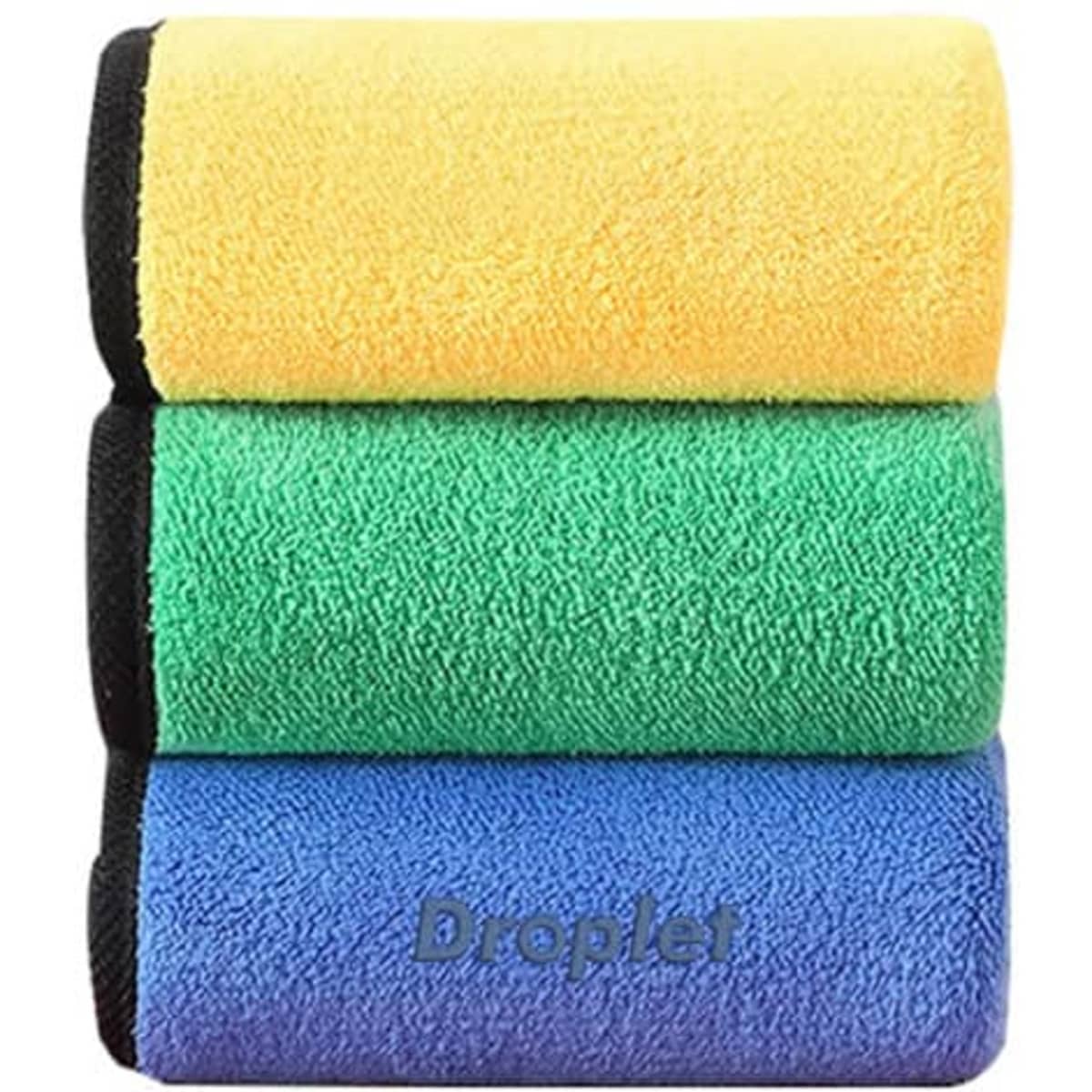 Three thickened coral velvet car cleaning cloths stacked, featuring yellow, green, and blue colours, with a branding logo visible.