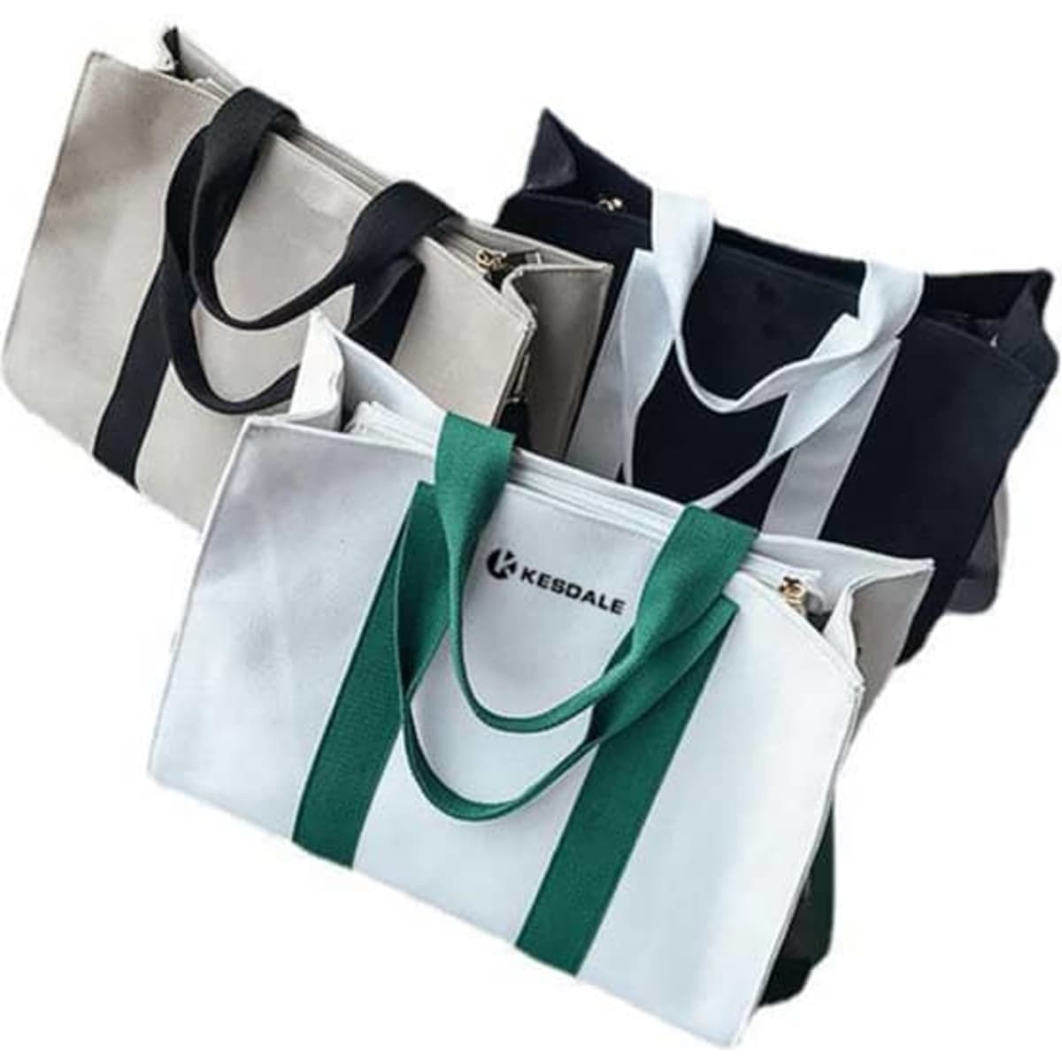 A collection of three vertical stripe canvas tote bags in cream, black, and white with green accents, each featuring a logo.