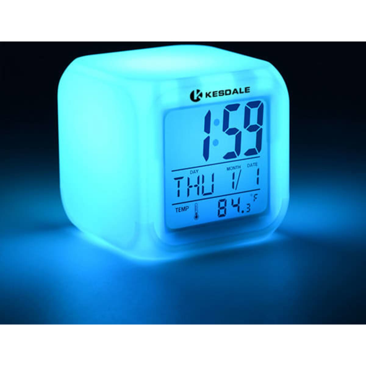 A cube-shaped alarm clock with a blue LED light, displaying time and date on a digital screen, featuring a logo.