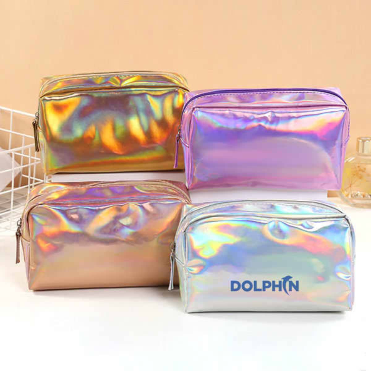 A set of four PVC holographic makeup pouches in shades of pink, silver, and purple, featuring one with a logo.
