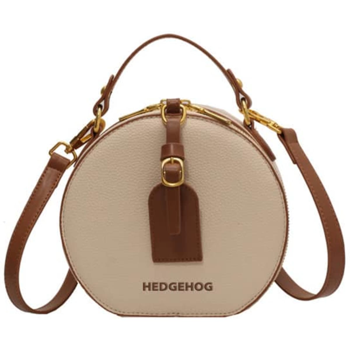 A round crossbody bag in beige with a brown strap and branding, featuring a stylish circular design.
