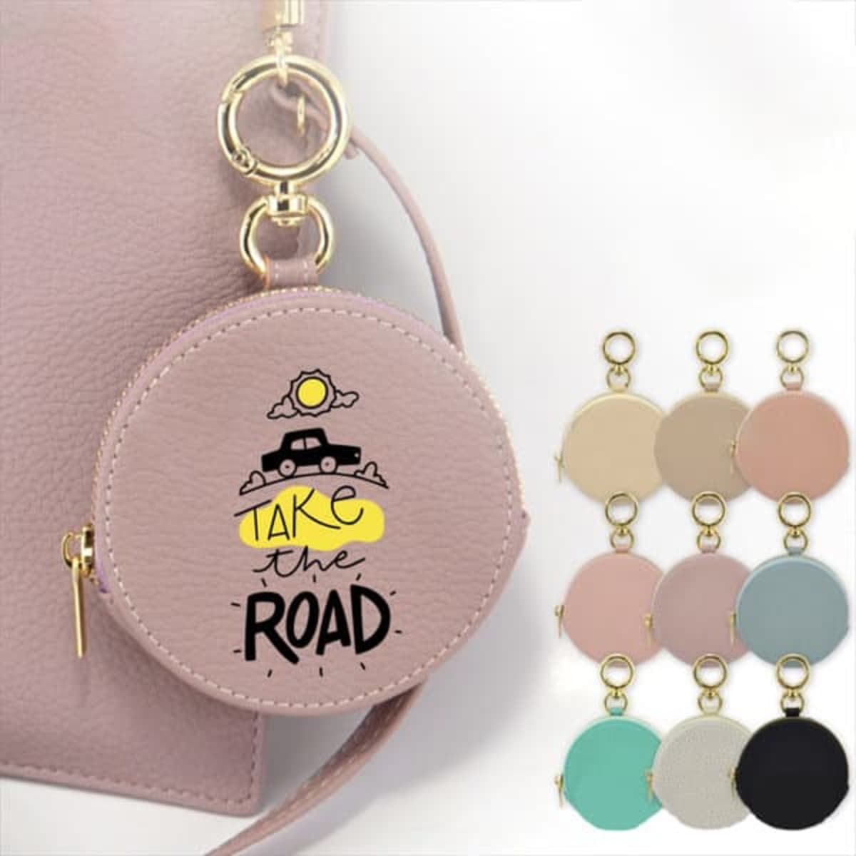 A round coin purse in light pink with a graphic design, featuring multiple colour options displayed alongside it.