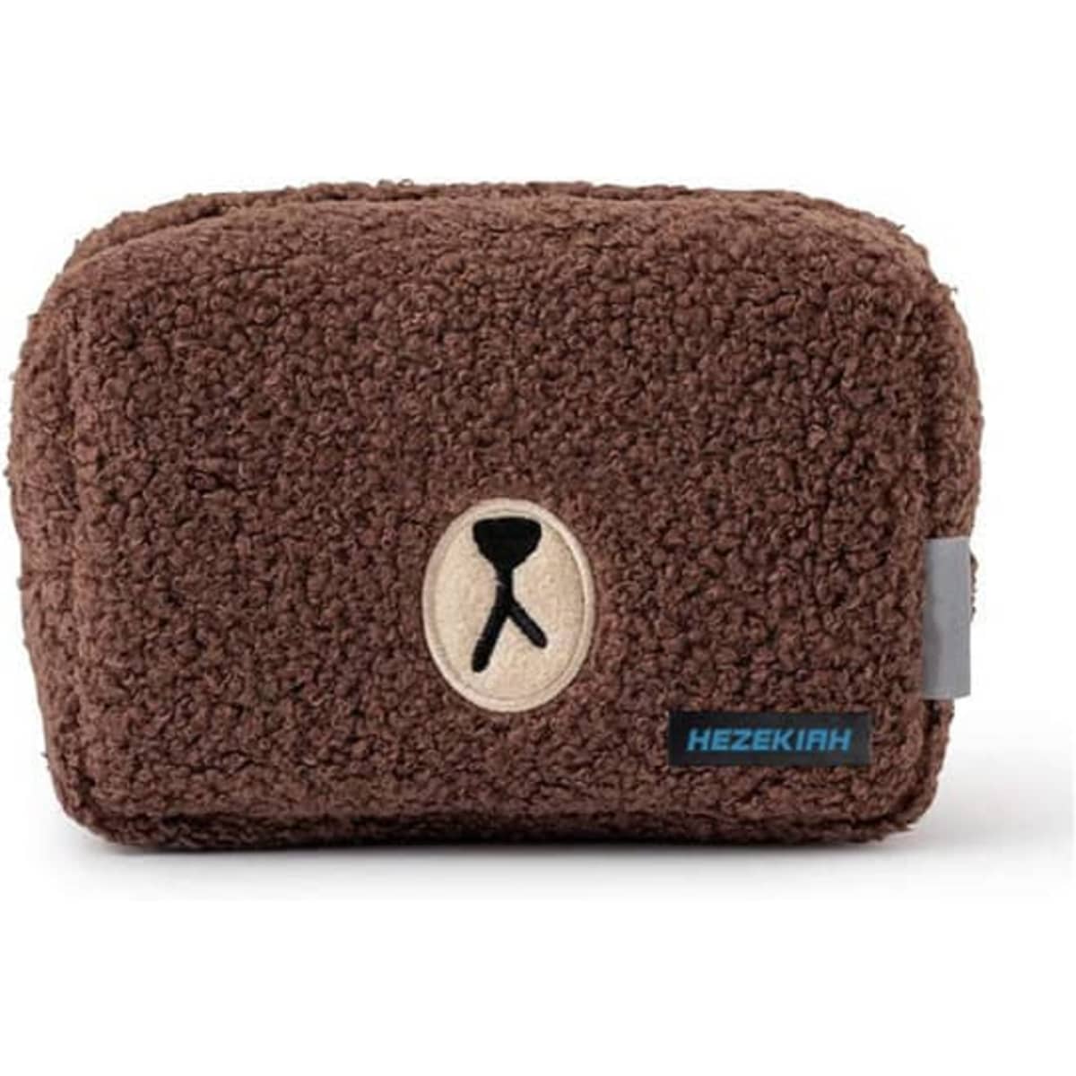 A brown plush makeup bag with a textured surface and a logo patch on the front.