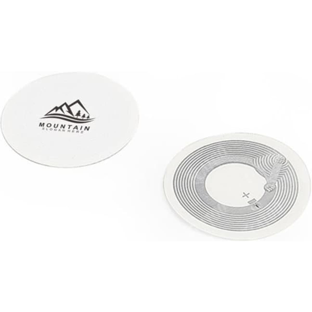 A round, white custom NFC tag sticker with a mountain logo and a circuit design on one side.
