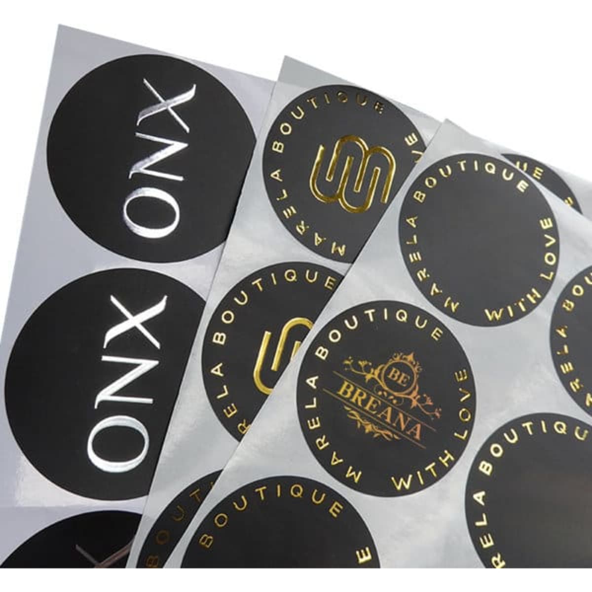 A collection of circular, custom hot stamping stickers in black and gold, featuring various logos and designs.