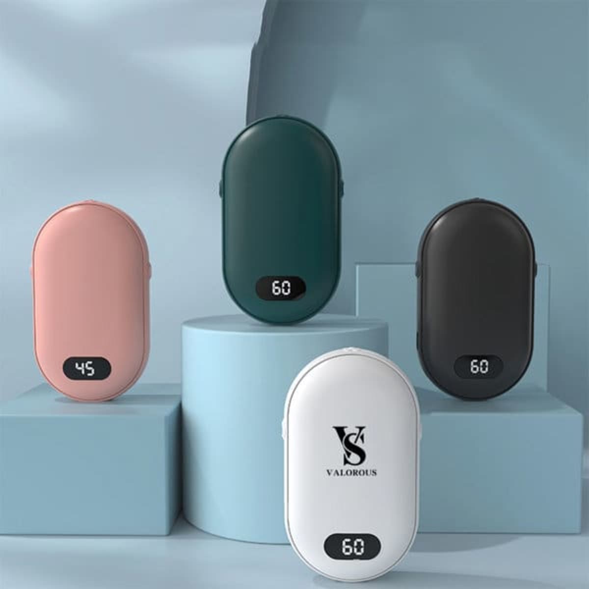 A collection of digital charging hand warmers in pink, green, black, and white, displayed on pastel pedestals.