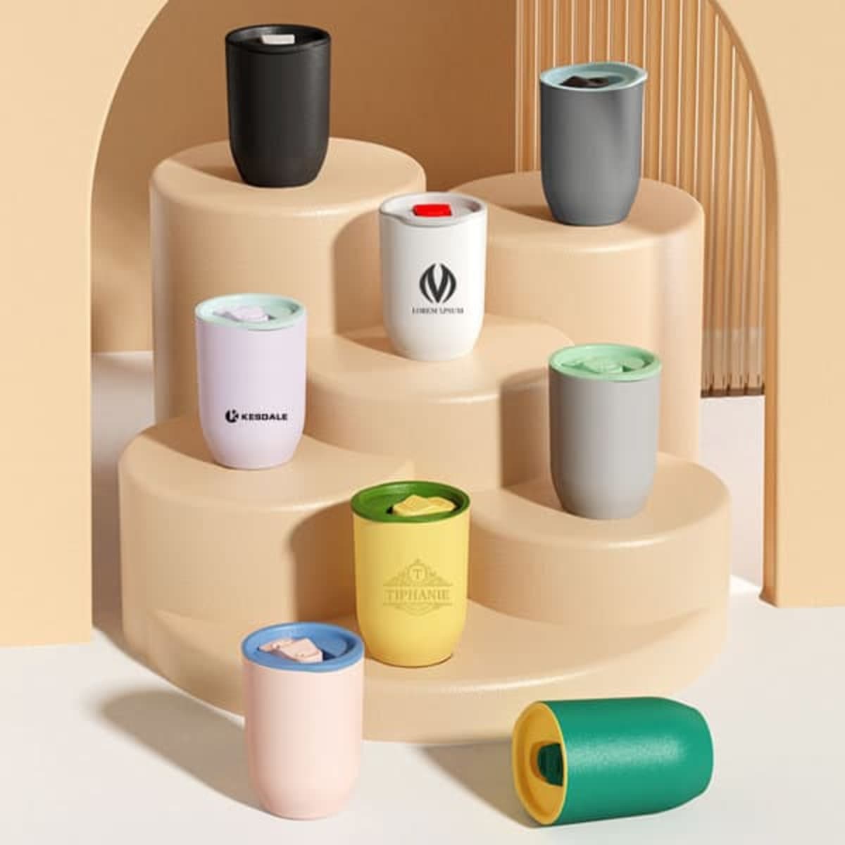 A collection of 12oz plastic egg-shaped tumblers in various colours, featuring lids and some with logos.
