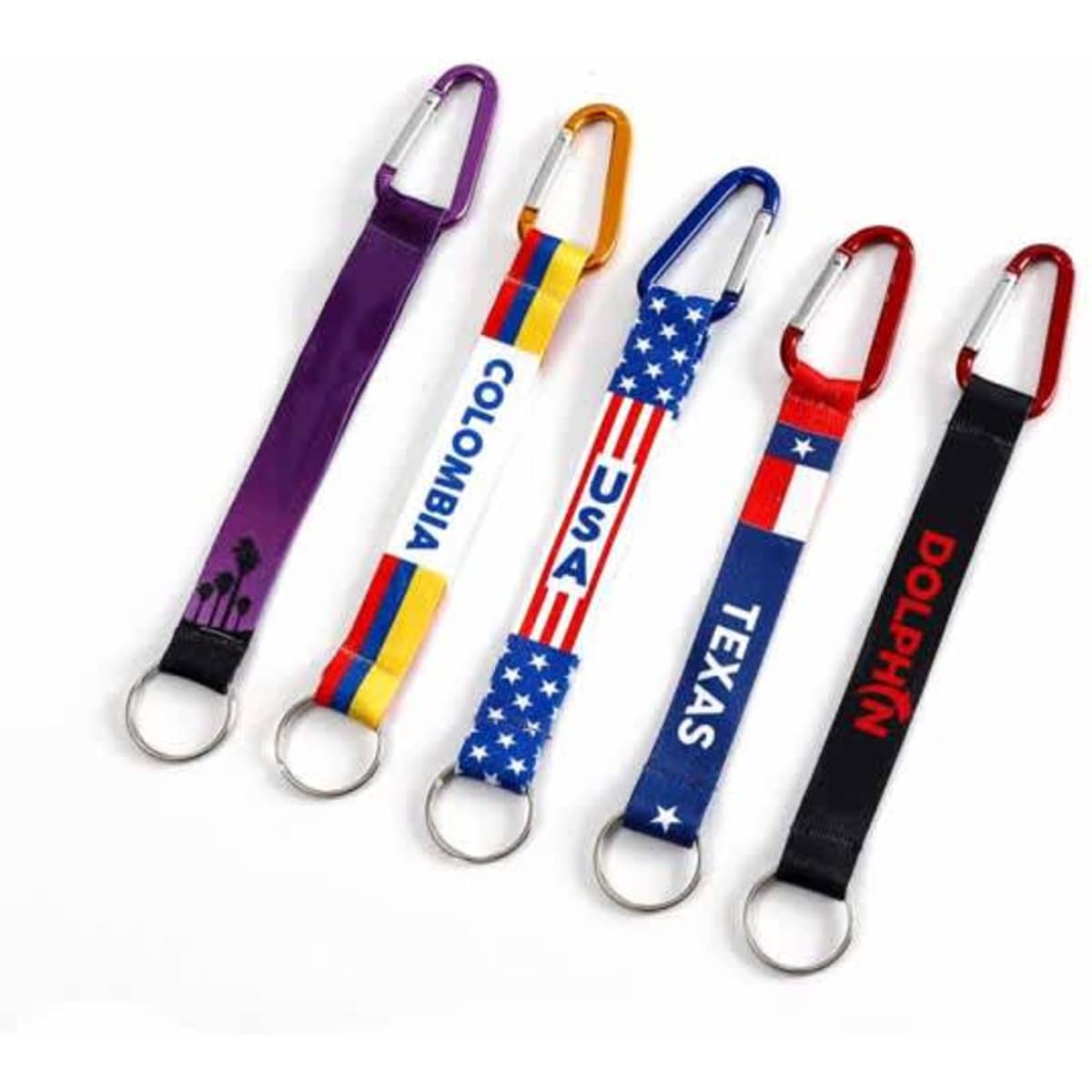A collection of five carabiner keychains with colourful straps featuring various designs and logos.