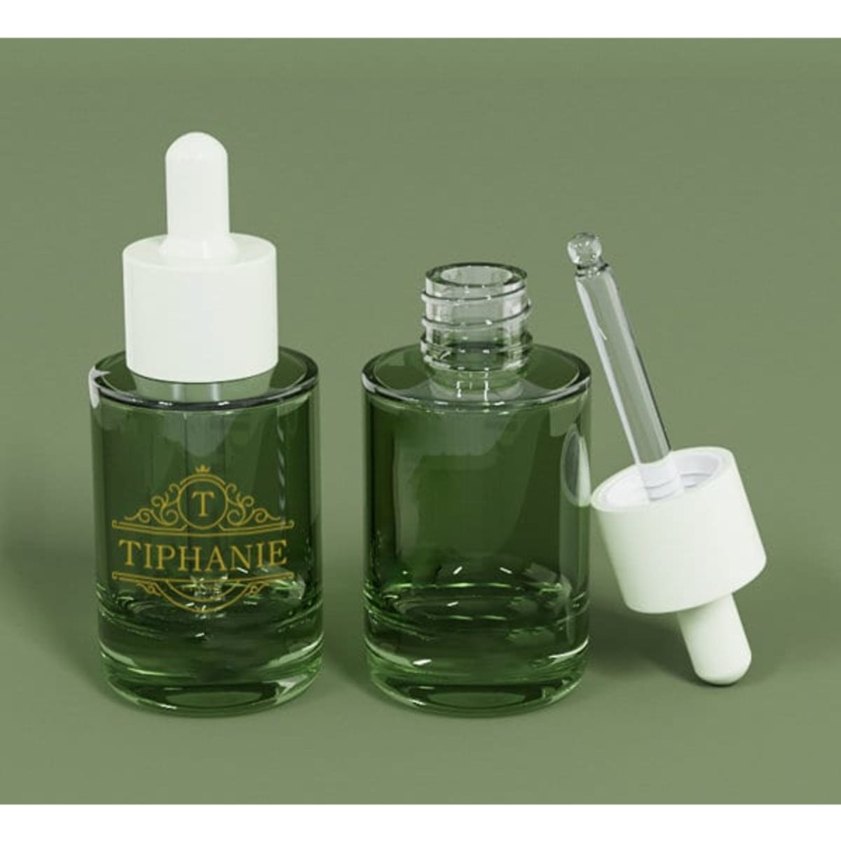 A green glass bottle with a dropper, featuring a white lid and a logo, alongside an empty glass bottle.