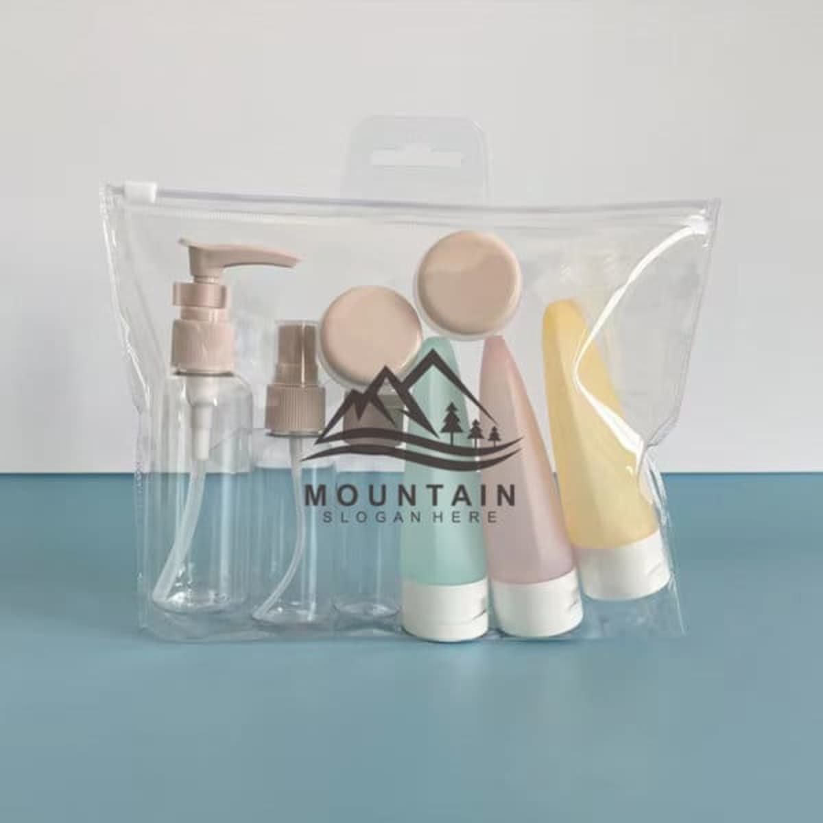 A PVC travel bottles set featuring three squeeze bottles in pastel colours and a clear pump bottle, all in a zippered pouch with a logo.