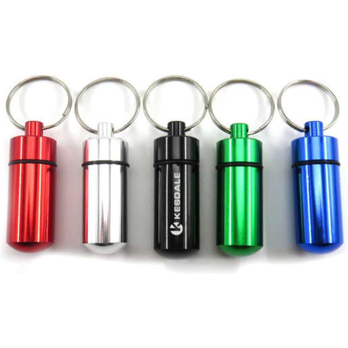 A collection of mini pocket pill box keychains in red, silver, black, green, and blue, featuring keyring attachments.