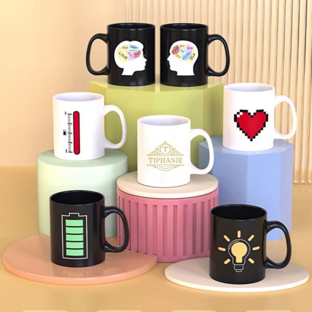 A collection of black and white ceramic mugs displayed on multi-coloured pedestals. Each mug features unique designs and logos.