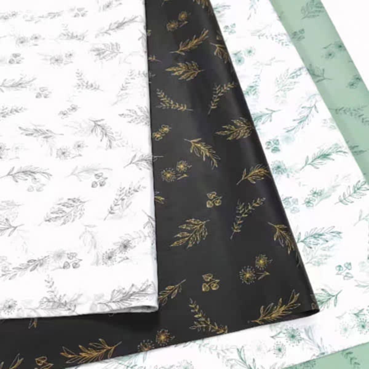 Custom Sydney Wrapping Paper in three designs: white with floral patterns, black with gold foliage, and green with botanical prints.