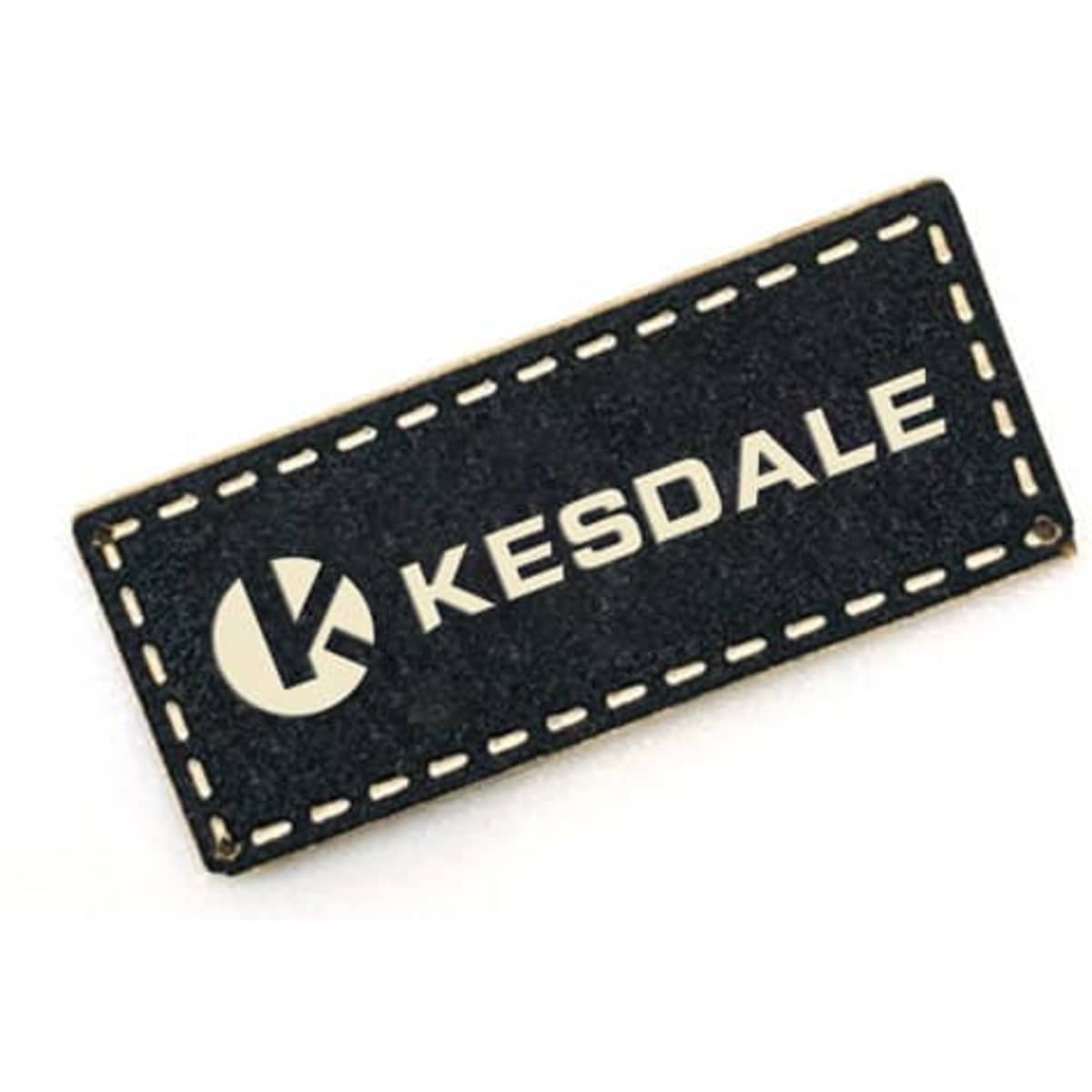 A black custom PU leather label with a stitched border and a logo. It features the text "KESDALE" in white.