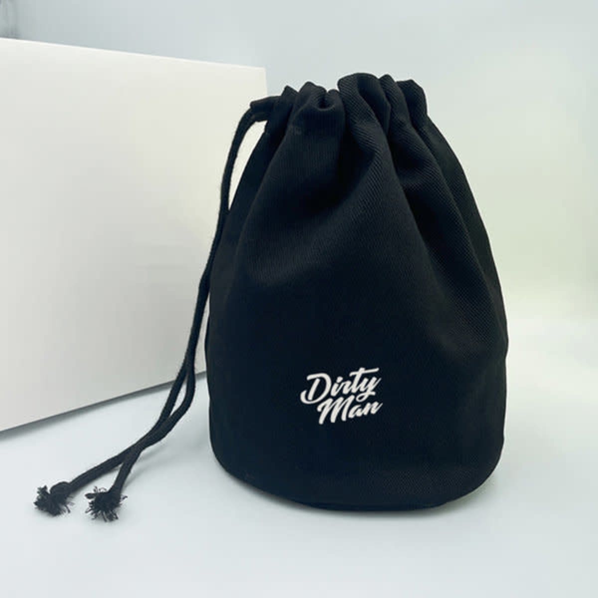 A black drawstring toiletry bag with a logo on the front, featuring a cinched closure at the top.