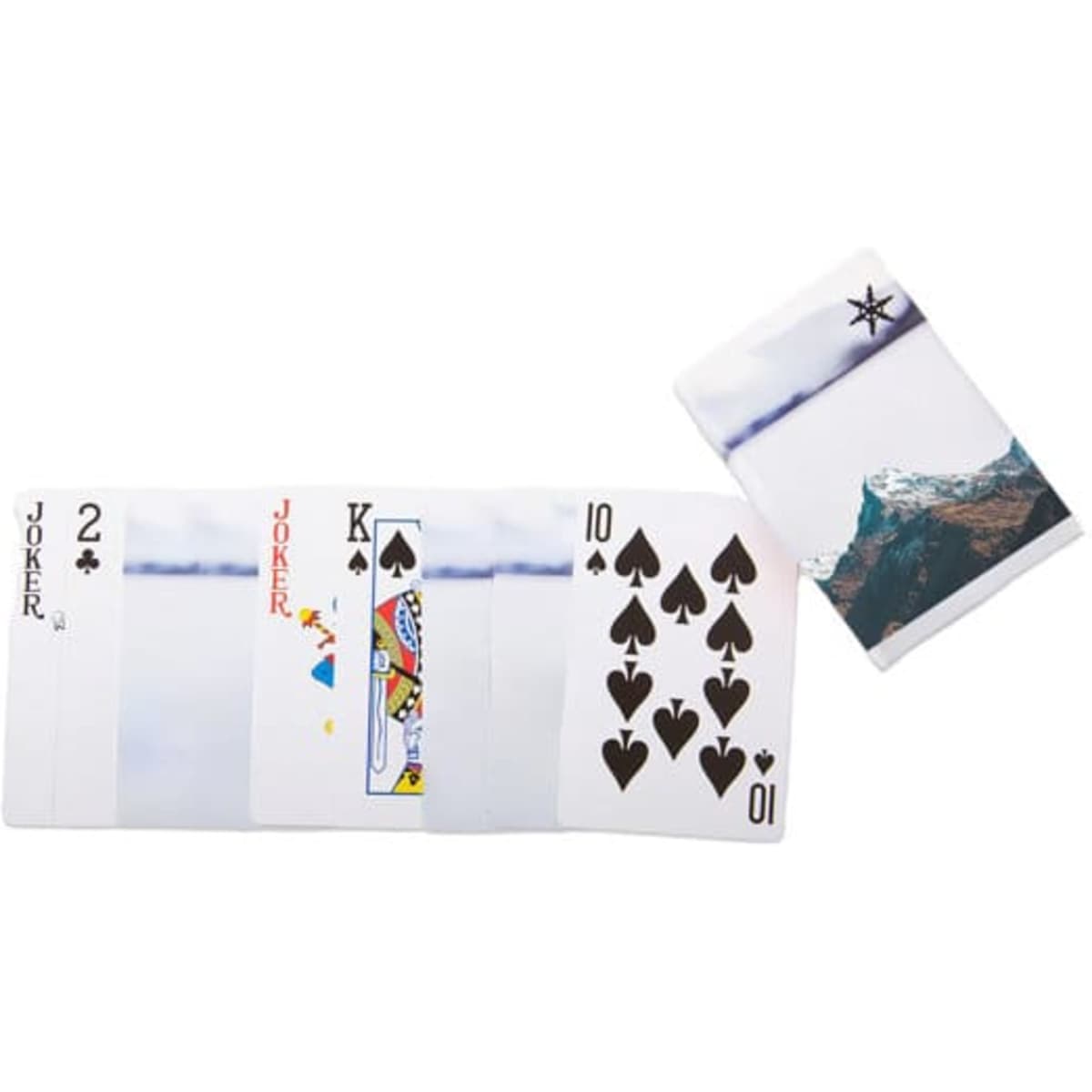 A set of poker cards in white featuring spade suits, Jokers, and a deck case with a mountain design.