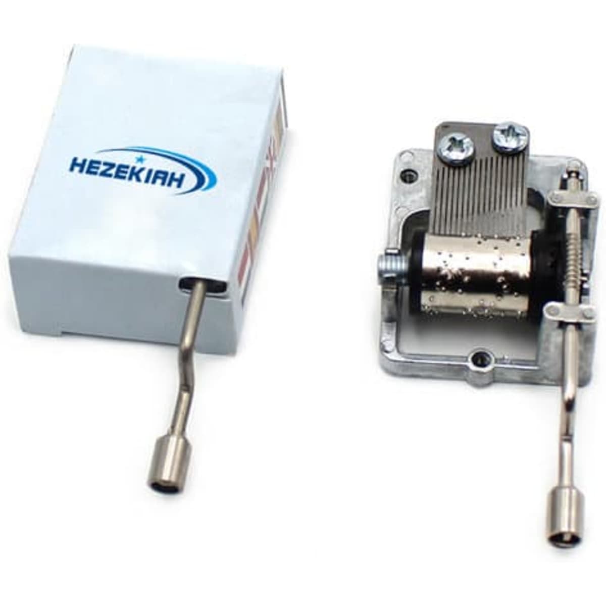 A hand crank music box in a white casing featuring a metal mechanism and a crank handle.