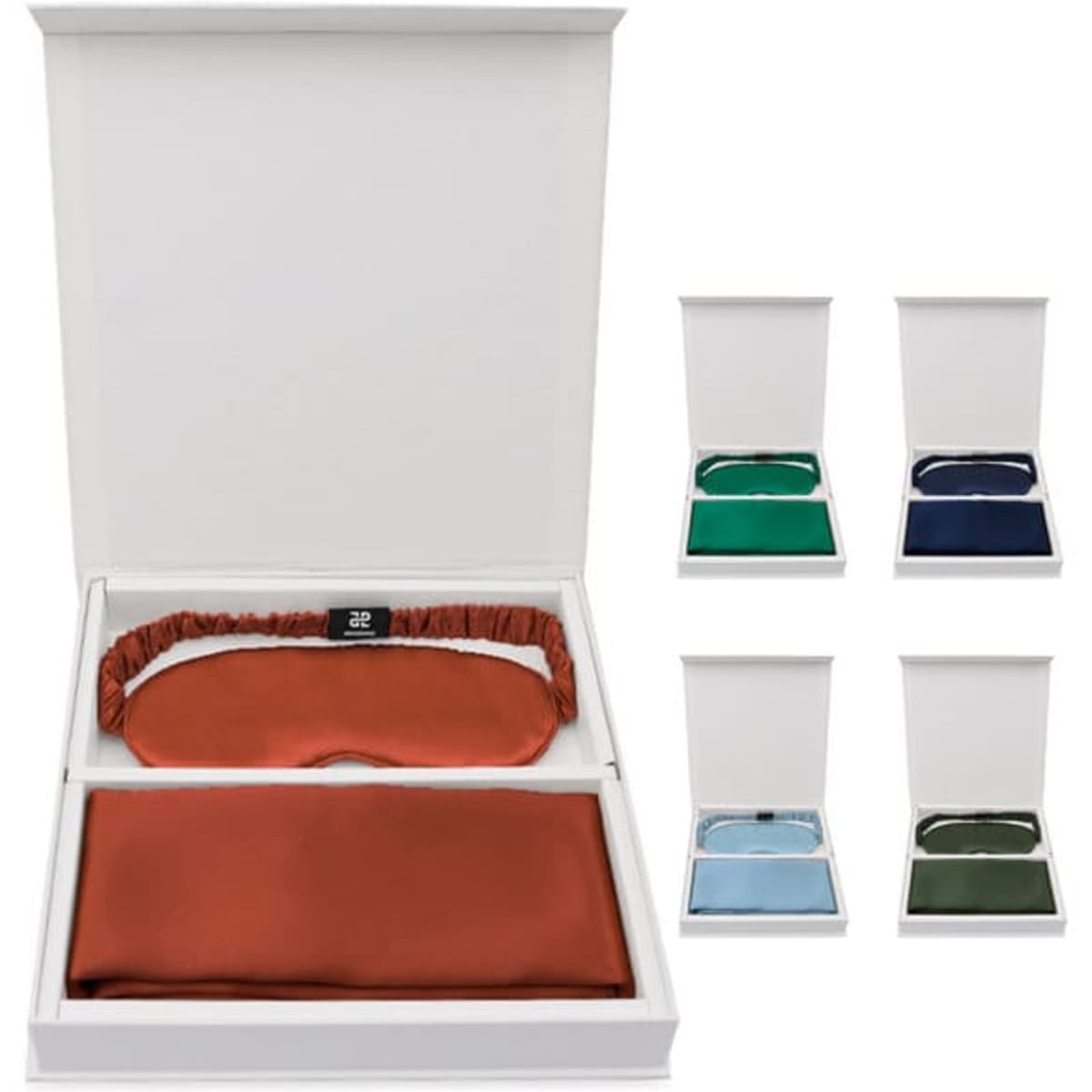 A gift set featuring a velvet pillowcase in rust and a matching eye mask, presented in a white box with various colours available.