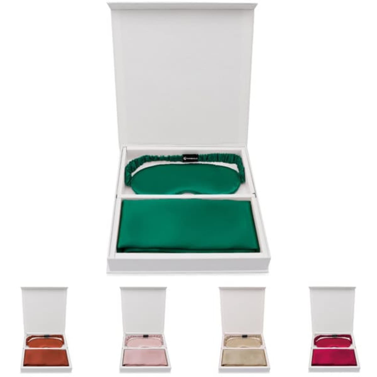 A gift box containing a green silk eye mask and three additional silk eye masks in various colours.
