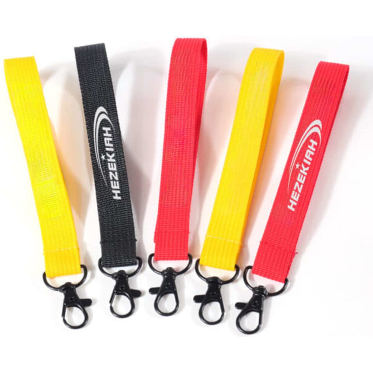 Five custom wrist lanyards in yellow, black, red, and another yellow, each featuring a clip.