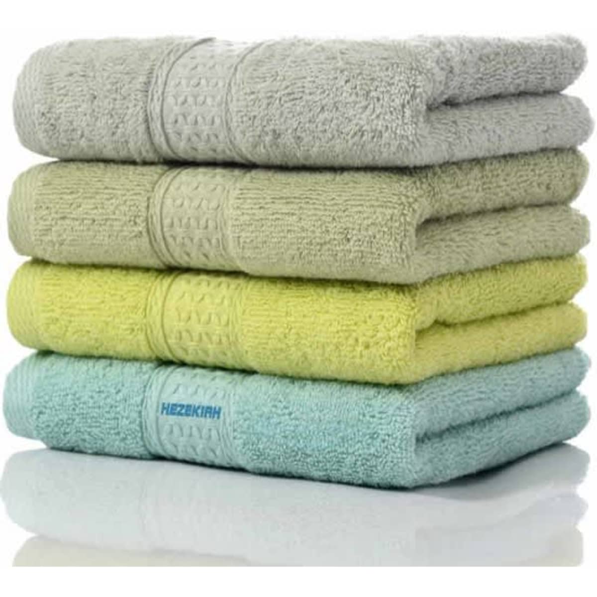 A stack of four bath towels in grey, light green, yellow, and light blue, with a logo on the bottom towel.