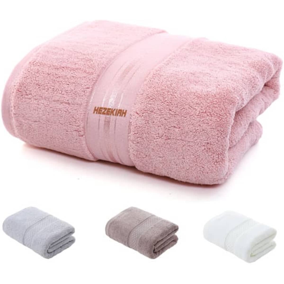 A pink extra large cotton bath towel is neatly folded, with grey, brown, and white towels folded beside it. The towel has a logo.