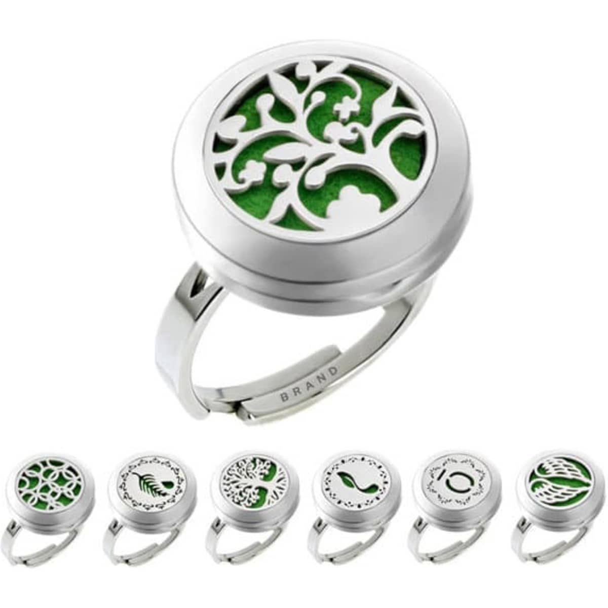 An adjustable silver essential oil diffuser ring with intricate designs and a green felt insert.