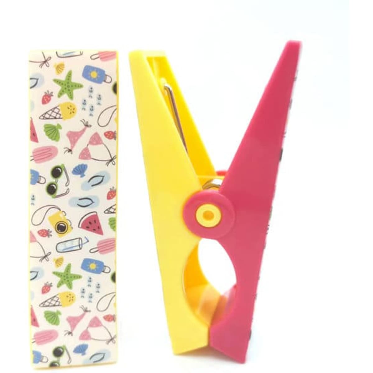 A pink and yellow windproof cloth clip next to a patterned card featuring various beach-themed illustrations.
