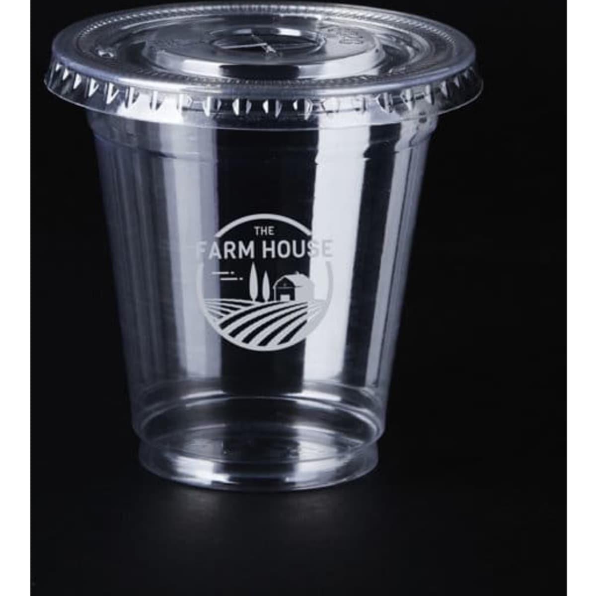 A clear 9 oz. PET cup with a lid, featuring a logo, set against a black background.