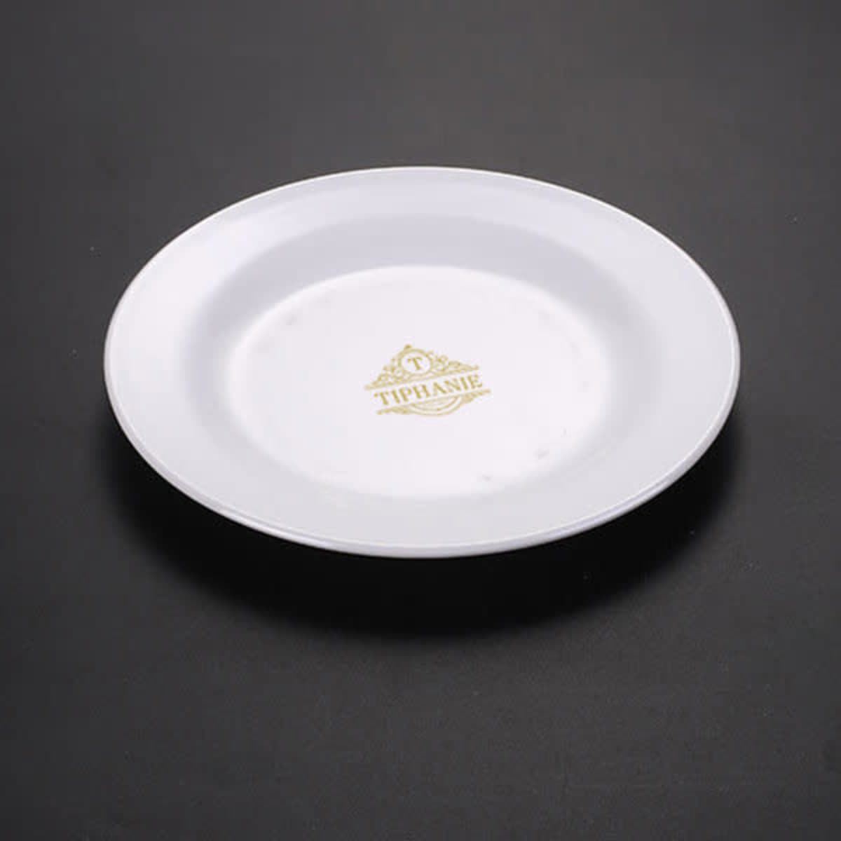 A white 8-inch round luncheon plate with a decorative logo in gold.