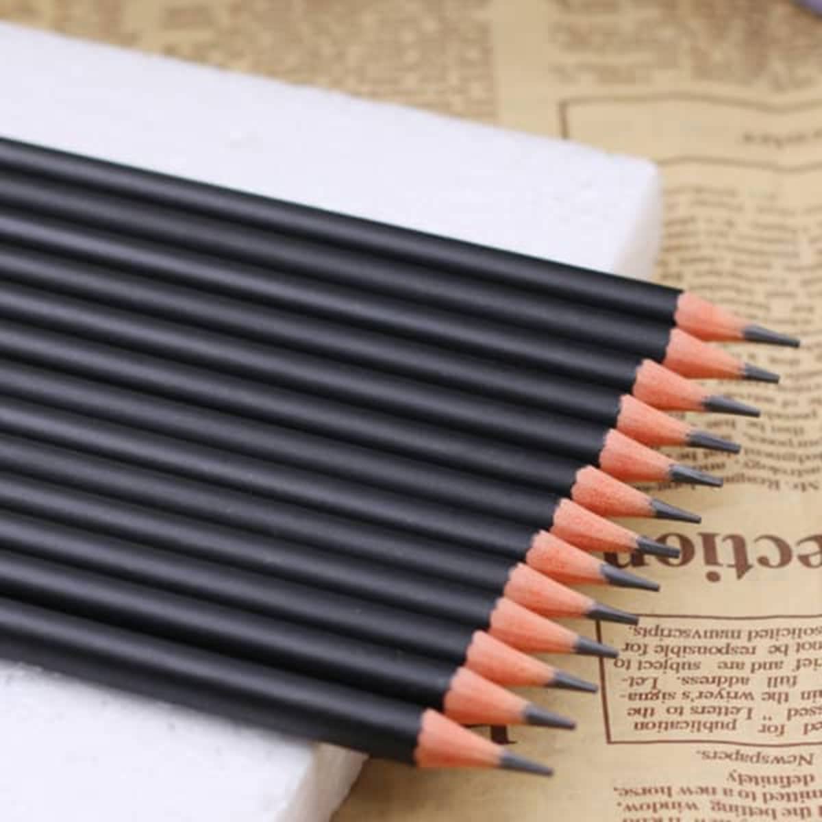 A collection of personalised graphite pencils in black with pink tips, arranged neatly in a row.