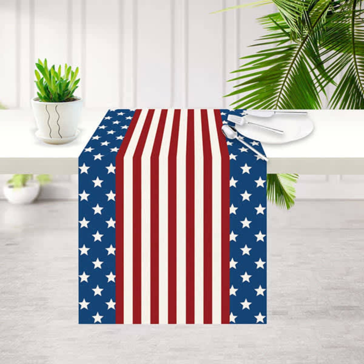 A rectangular tablecloth featuring a red, white, and blue star and stripe pattern. It has a logo.