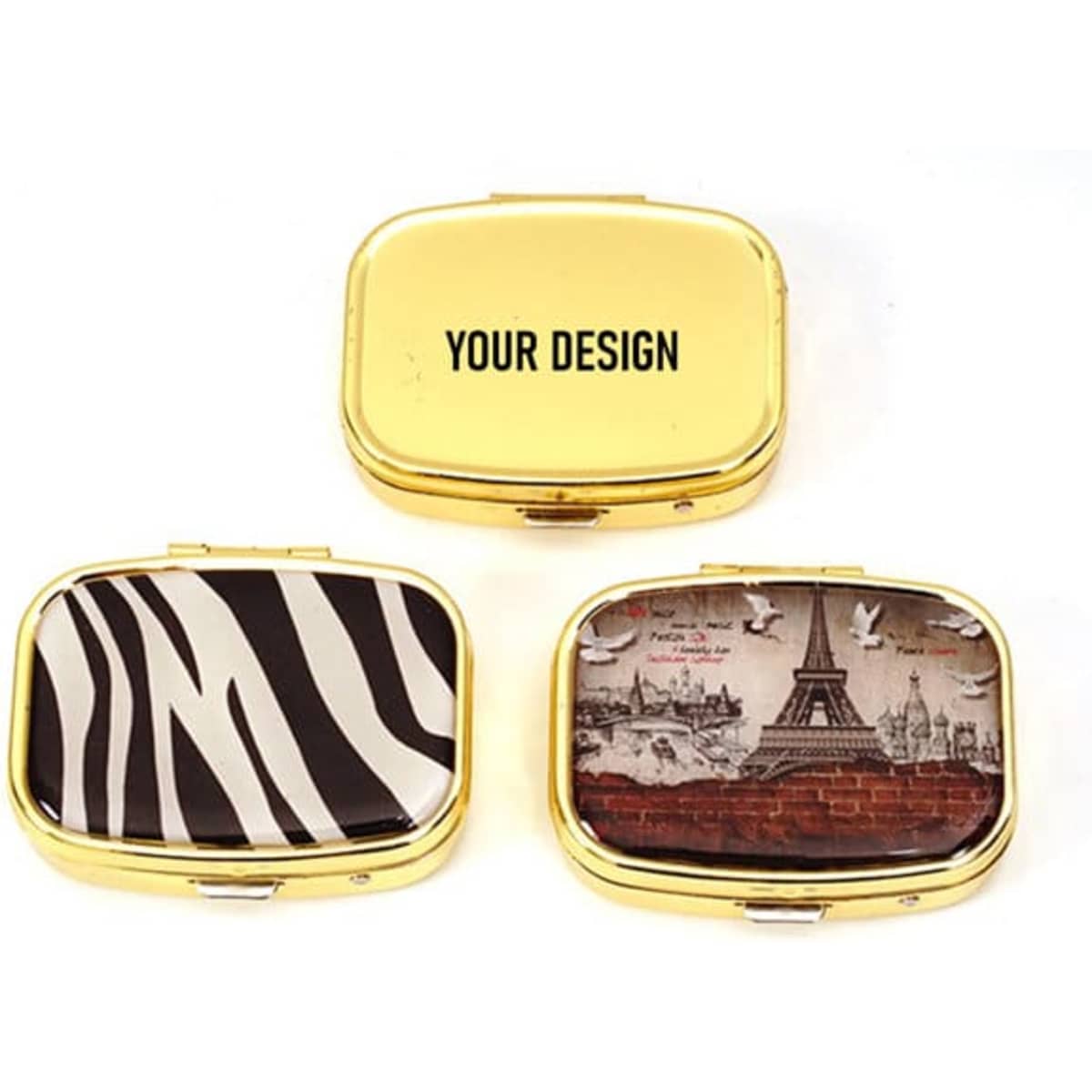 Three metal pill boxes with mirrors in gold, featuring zebra print and a vintage Paris design. Each has a branding logo.
