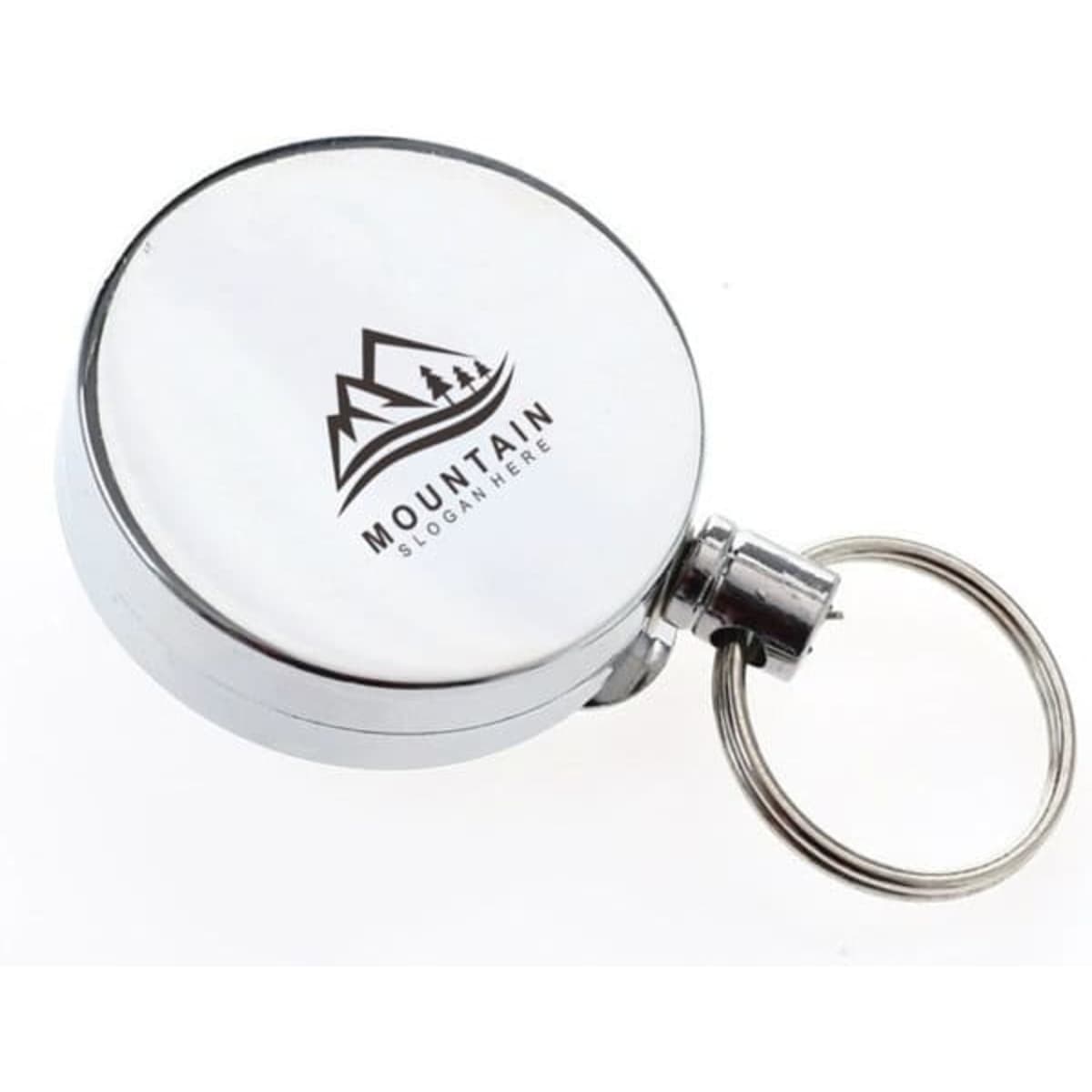 A circular silver retractable badge holder with a keyring attachment and a logo featuring mountains.