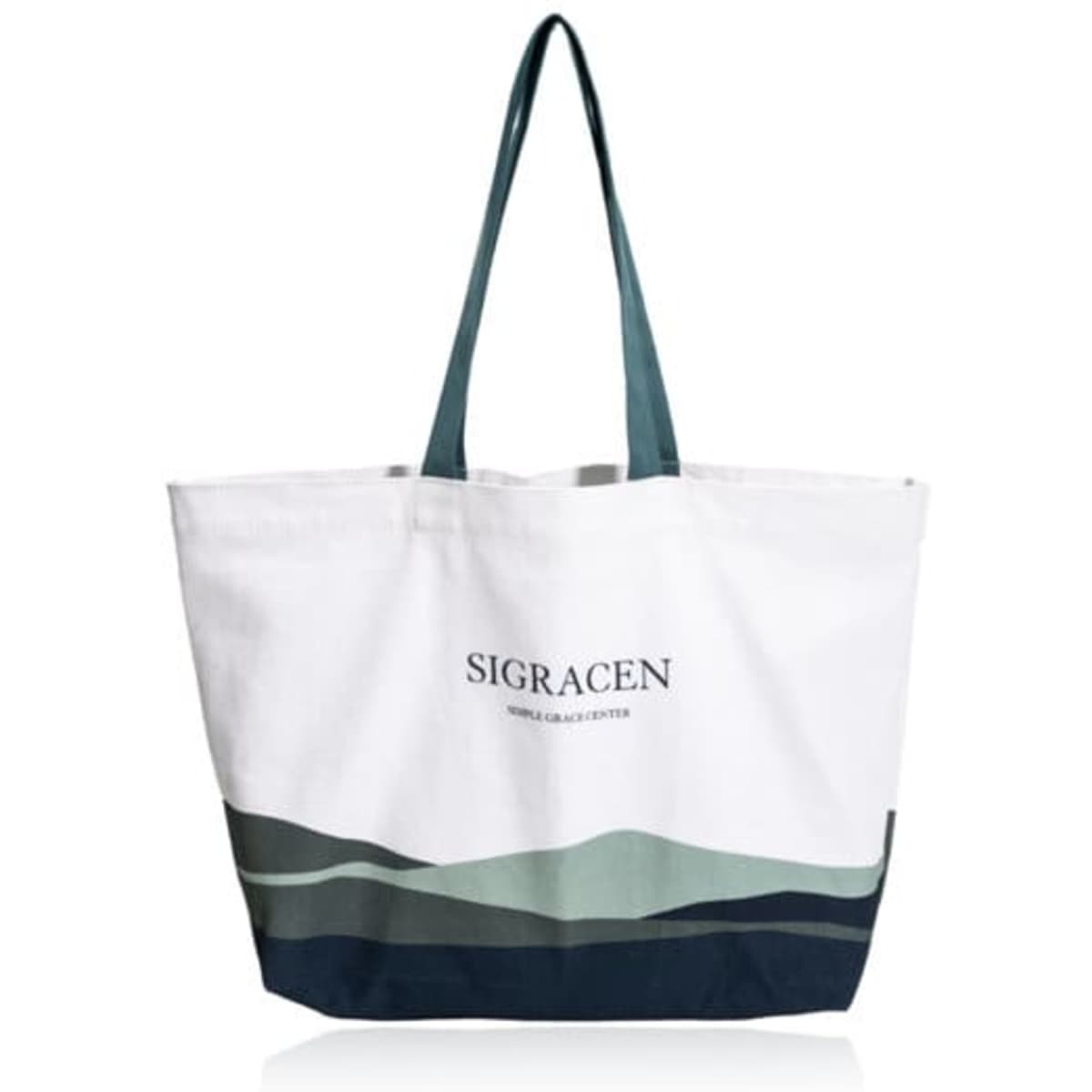 A canvas tote bag in white with a green and navy wave design, featuring a logo on the front.