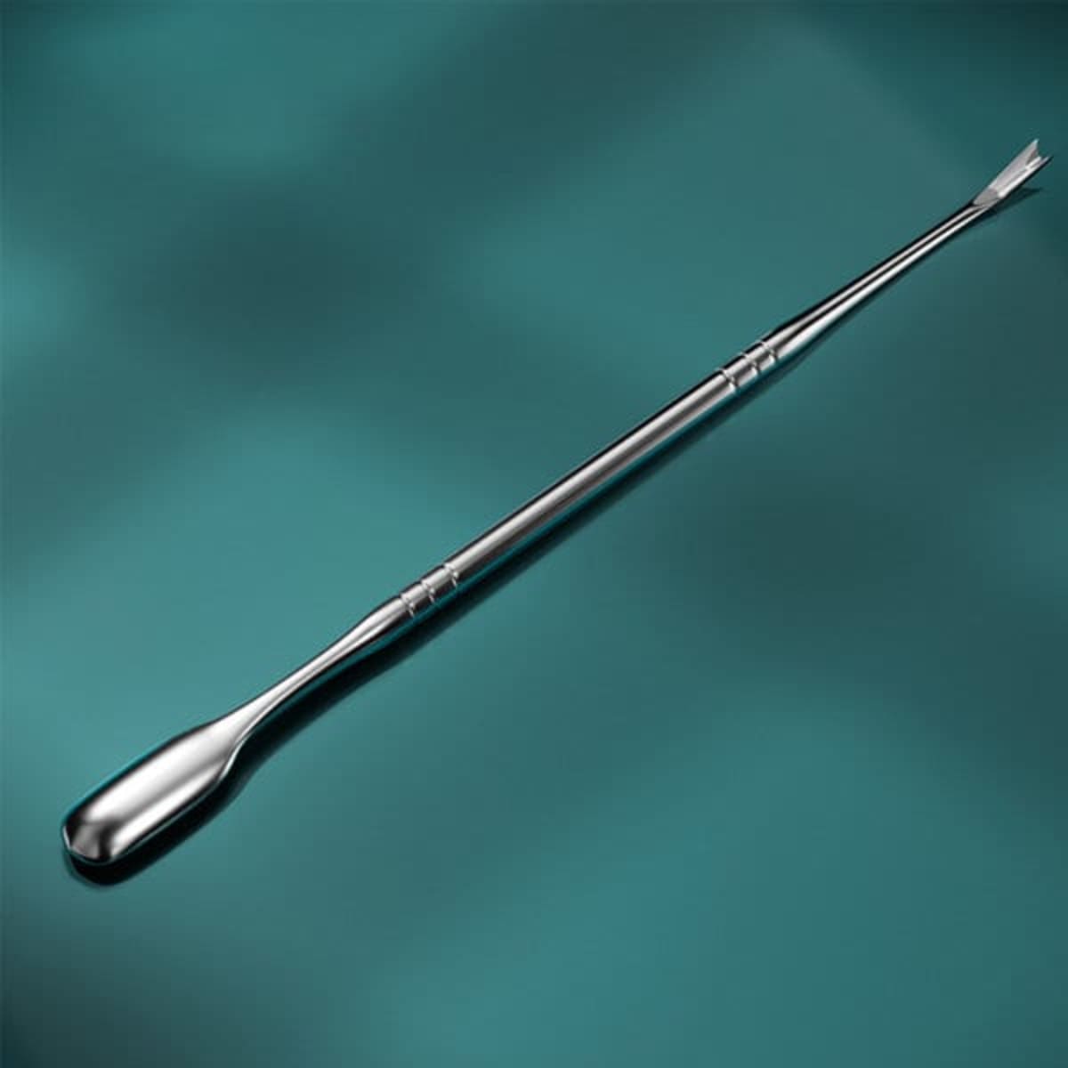 A stainless steel cuticle pusher with a smooth, shiny finish and a double-ended design on a teal background.