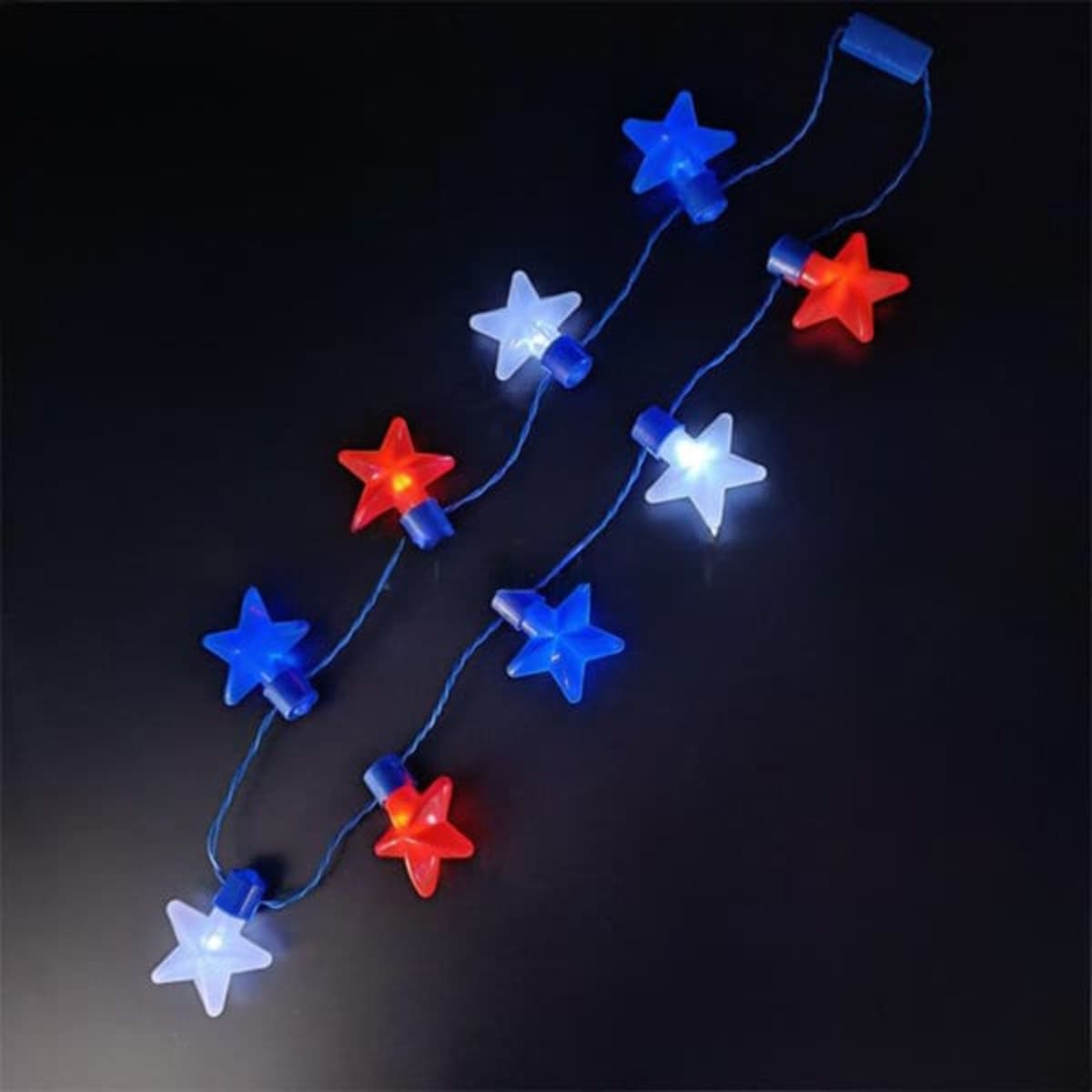 A string of star-shaped lights featuring red, white, and blue colours on a dark background.