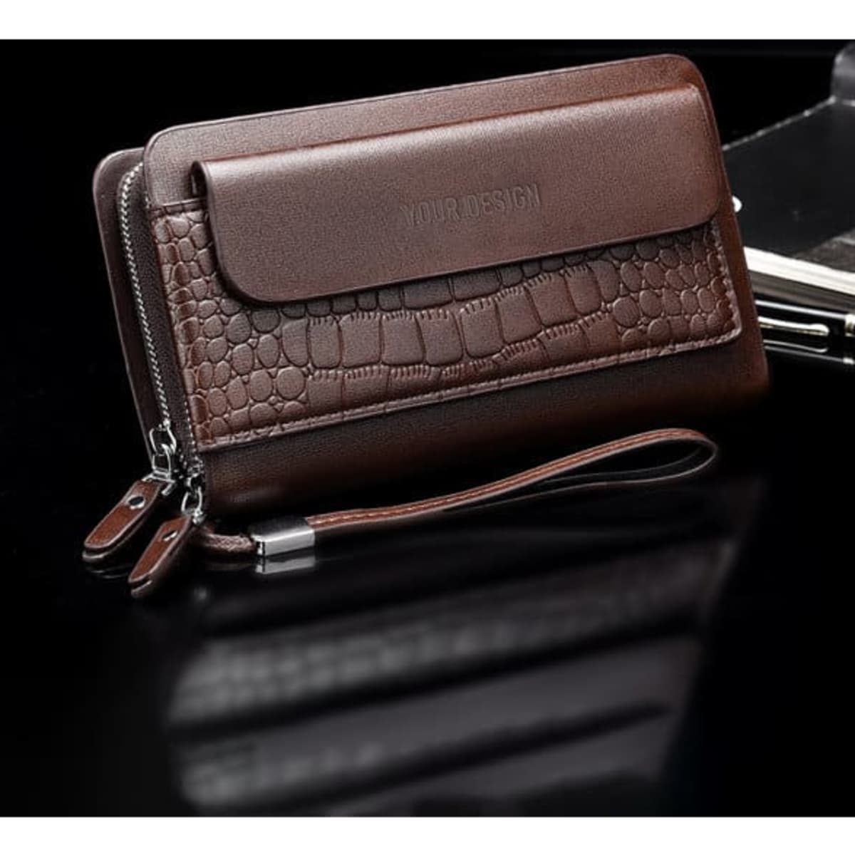 A large capacity brown wallet featuring a textured panel, double zippers, and a wrist strap. It has a logo.