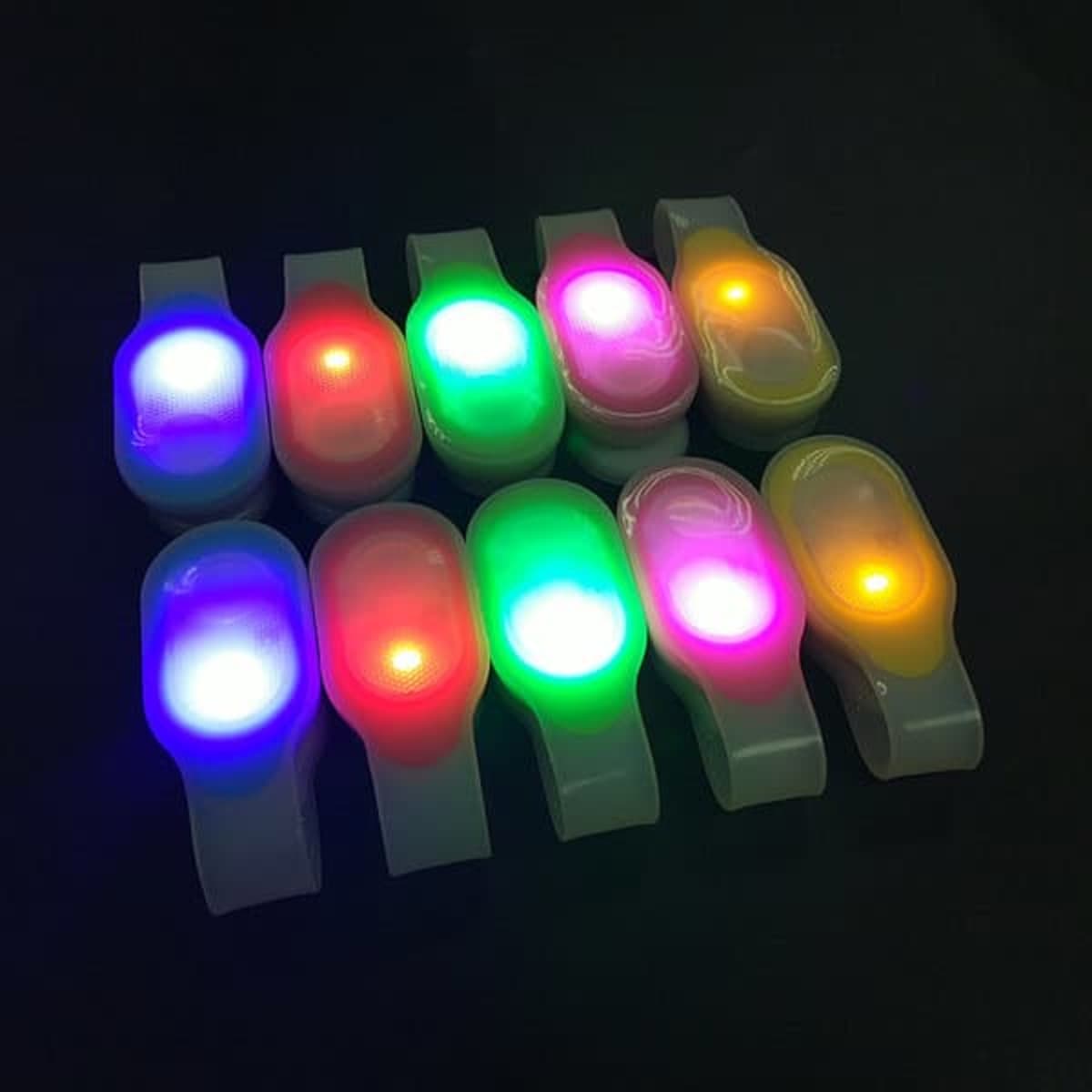 A collection of multi-coloured clip-on LED lights in various bright colours, featuring multiple glowing lights.