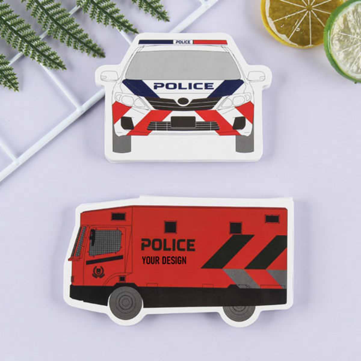 A set of custom sticky note pads shaped like a police car and an armoured vehicle, featuring red and blue designs.