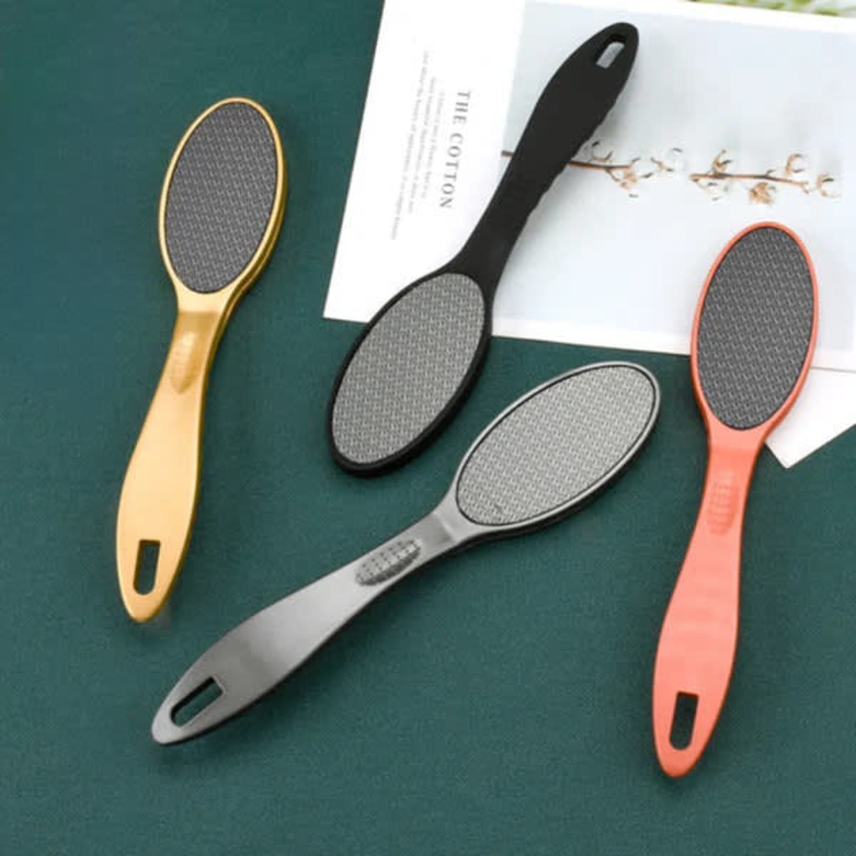 A set of portable foot file callus removers in gold, black, grey, and red, with textured surfaces.