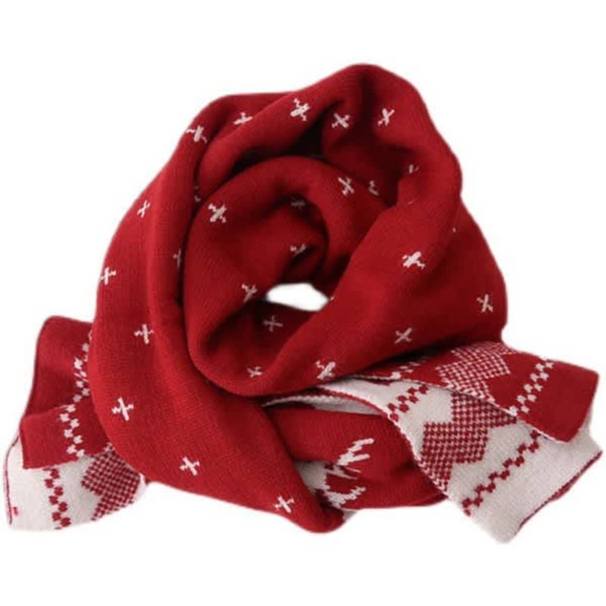 A red double-sided Christmas scarf featuring white patterns and stitches. It has a soft, knitted texture.