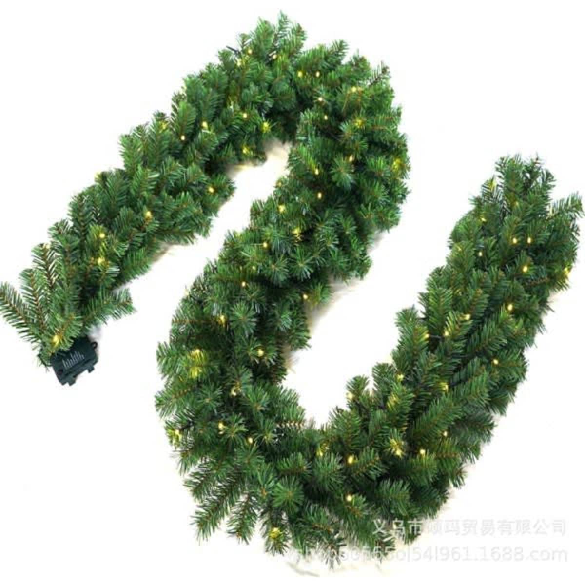 A green rattan garland with warm white lights, featuring a flexible design suitable for decoration.